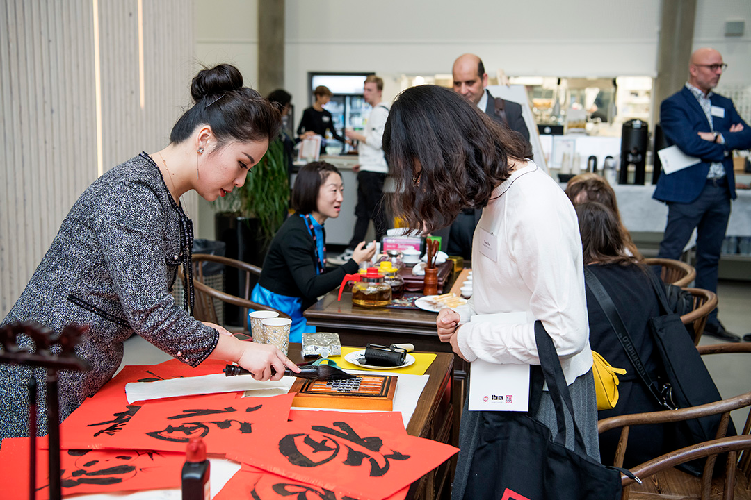 Picture of people trying Chinese calligraphy