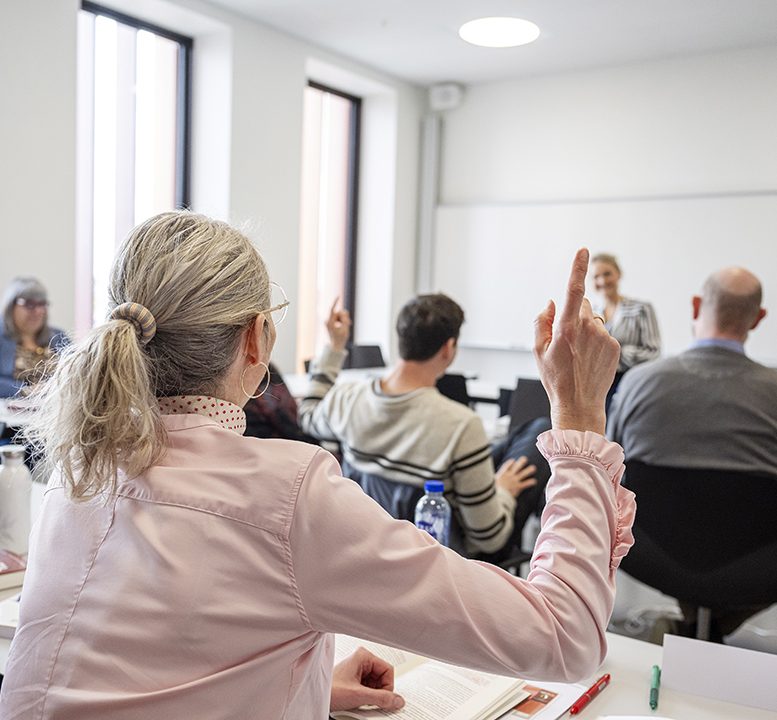 Studerende på IBA's efteruddannelse med fingeren i vejret.