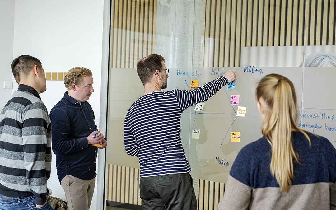Underviser og studerende der samarbejder.