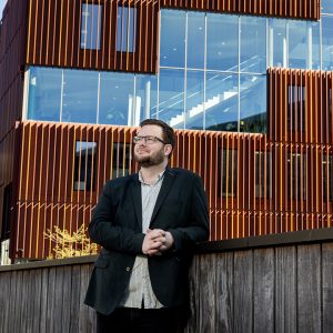 Photo of Martin standing in front of the IBA building